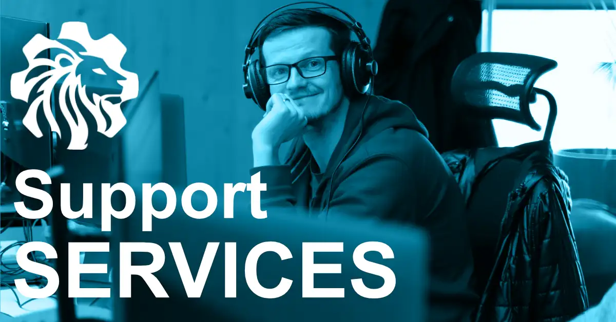 Website Support specialist with headphones, seated behind multiple monitors, smiling directly at the camera.